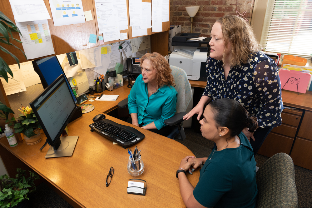 Three people at a desk
