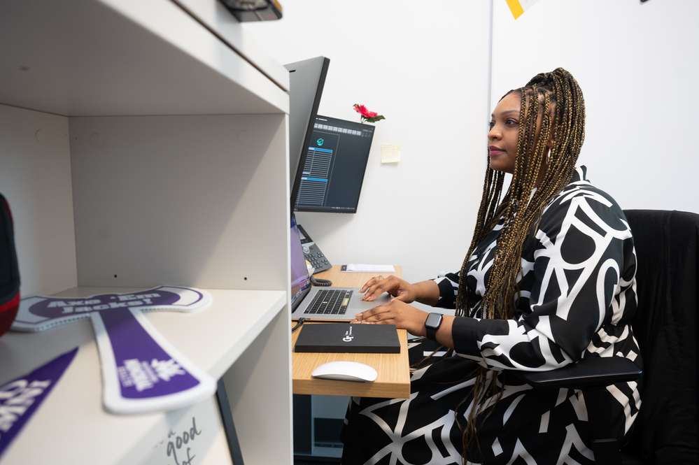 A woman sitting at a desk typing