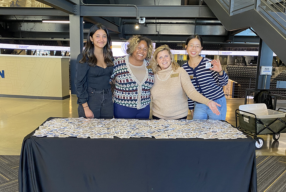 Smiling people stand at a table