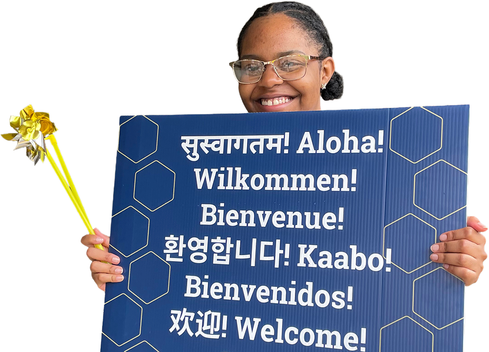 A person holding a welcome sign