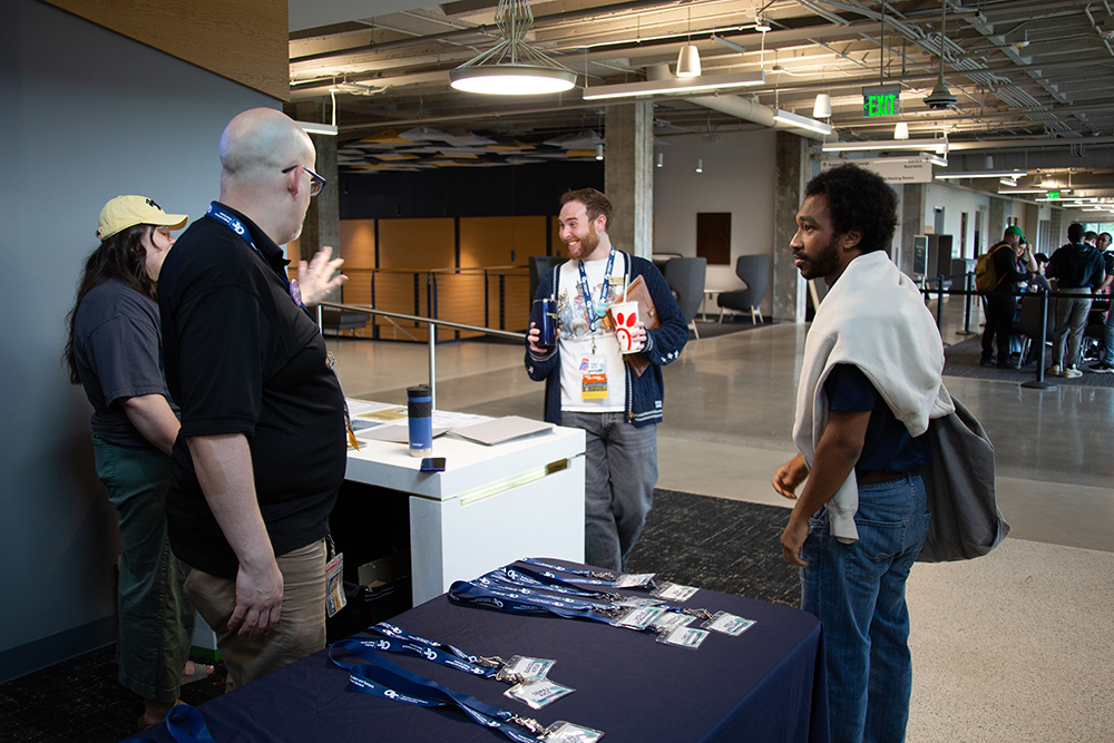 People stand at a check-in table